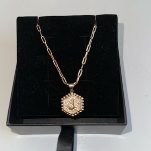 Initial J gold necklace.